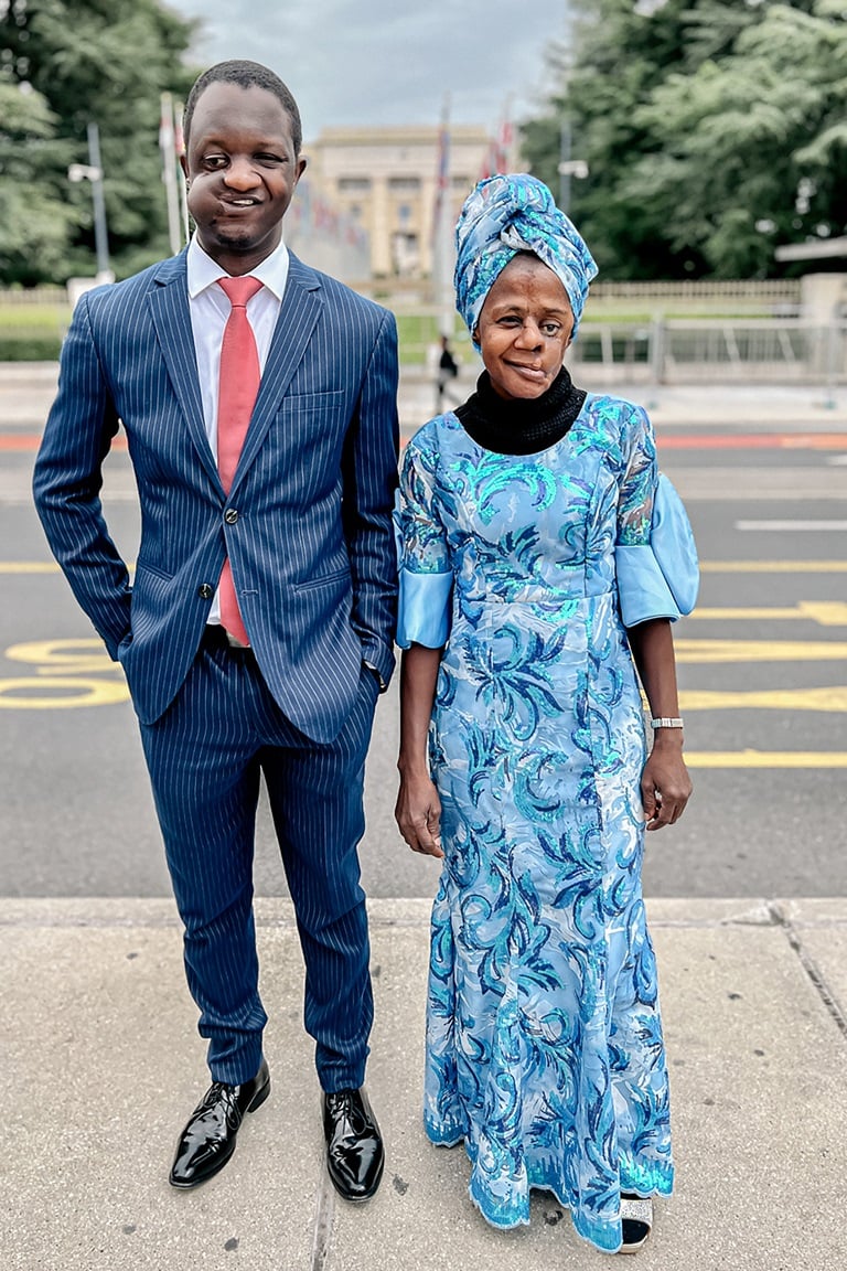 Two people standing on the sidewalk